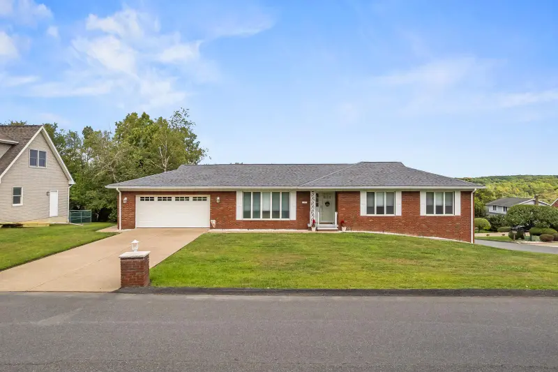 Brick ranch home with a wide front lawn in Plains, Pennsylvania