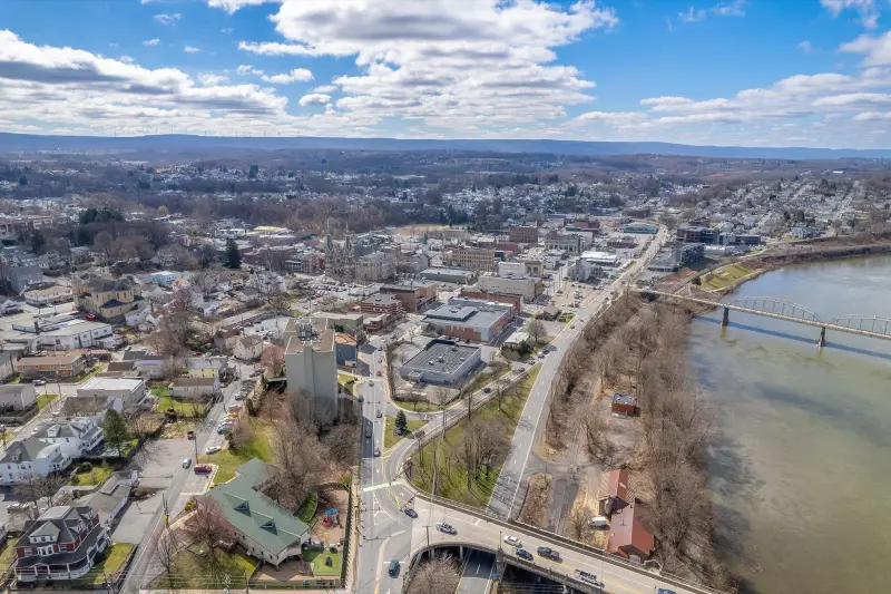Aerial view of a Northeastern Pennsylvania river town, with the Susquehanna River and a bridge in the foreground