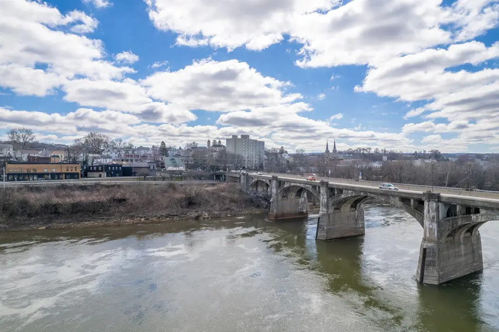 Stone arch bridge over the Susquehanna River at Pittston under a partly cloudy sky